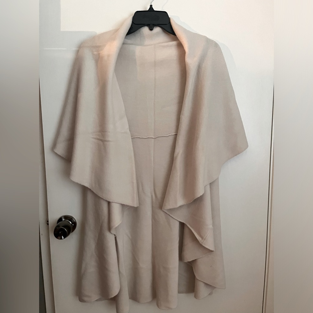 Cream color jacket. Sleeveless w/ large flap over shoulder. Beautiful & stylish